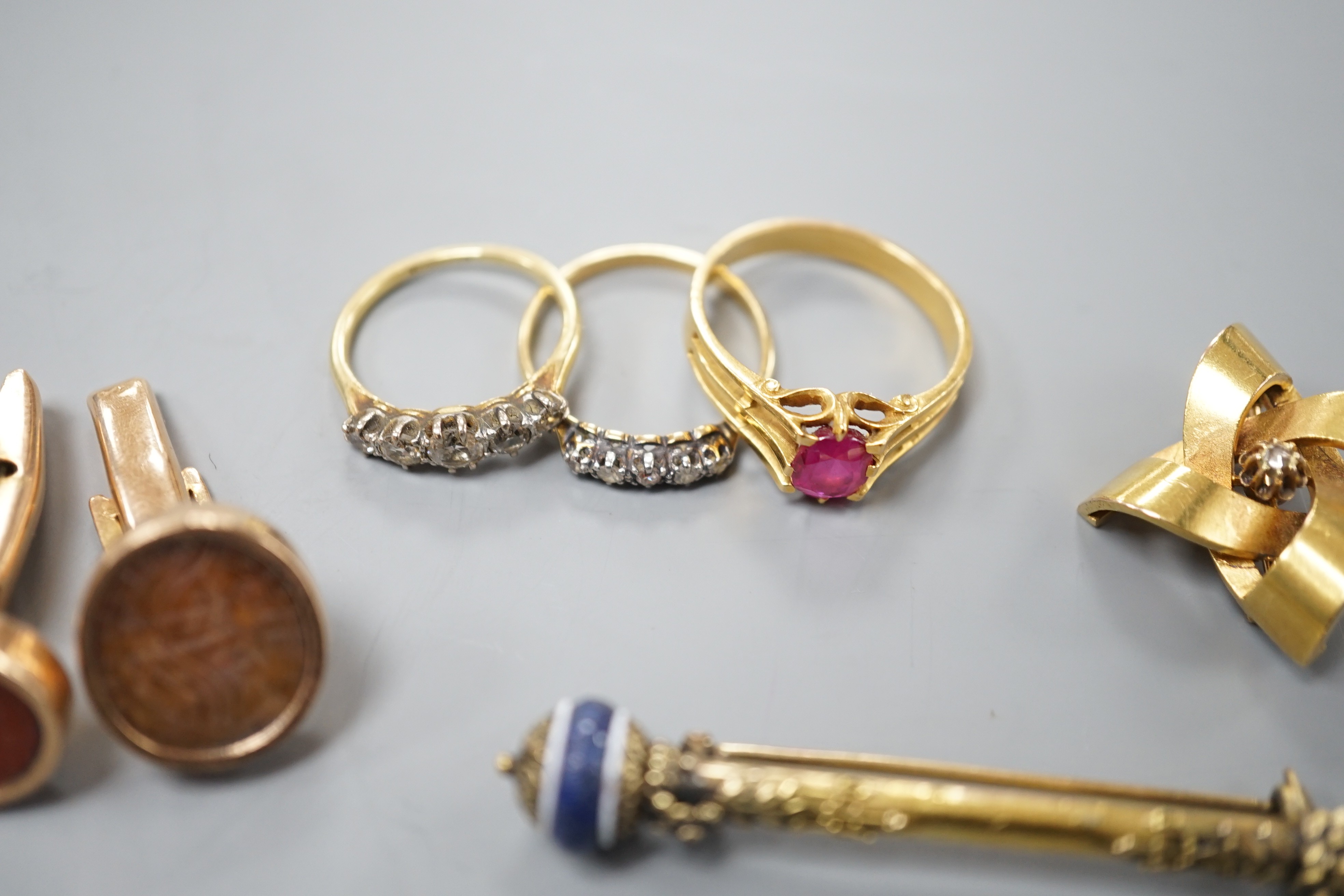 A group of mixed jewellery including two 18ct and diamond half hoop rings, a pair of Middle Eastern yellow metal and talismanic carnelian intaglio cufflinks, a yellow metal and diamond set brooch, a synthetic? ruby set y